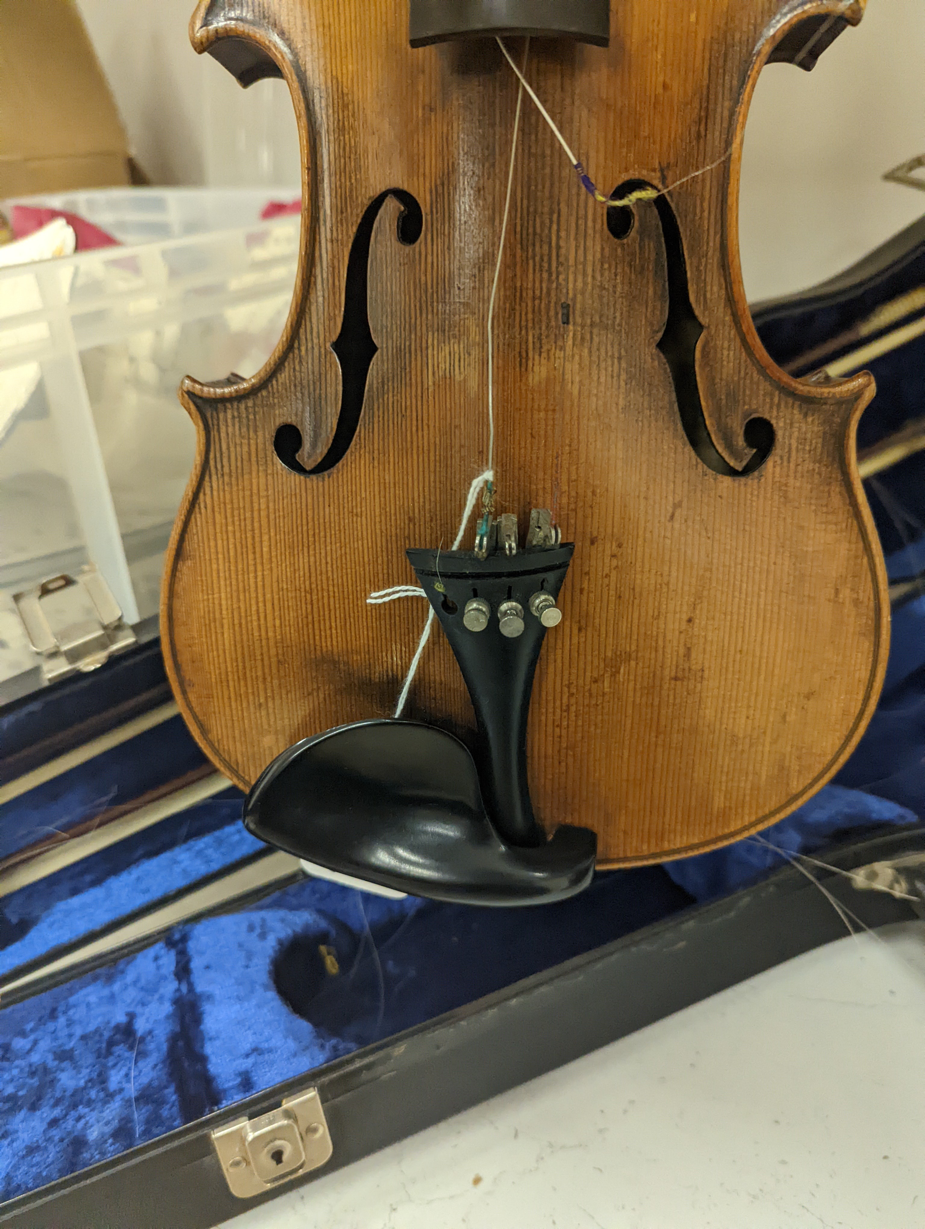 An early 20th century French or English violin with two bows, each stamped